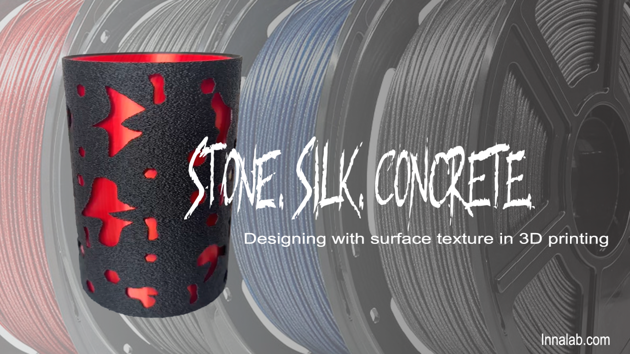 Black matte stone-textured vase with scarlet silk interior surrounded by filament spools